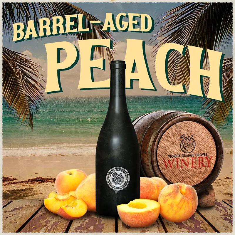 Black wine bottle with peaches and a barrel on a beach setting, labeled 'Barrel-Aged Peach'.