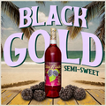 Black Gold semi-sweet wine bottle with blackberries on a beach-themed background