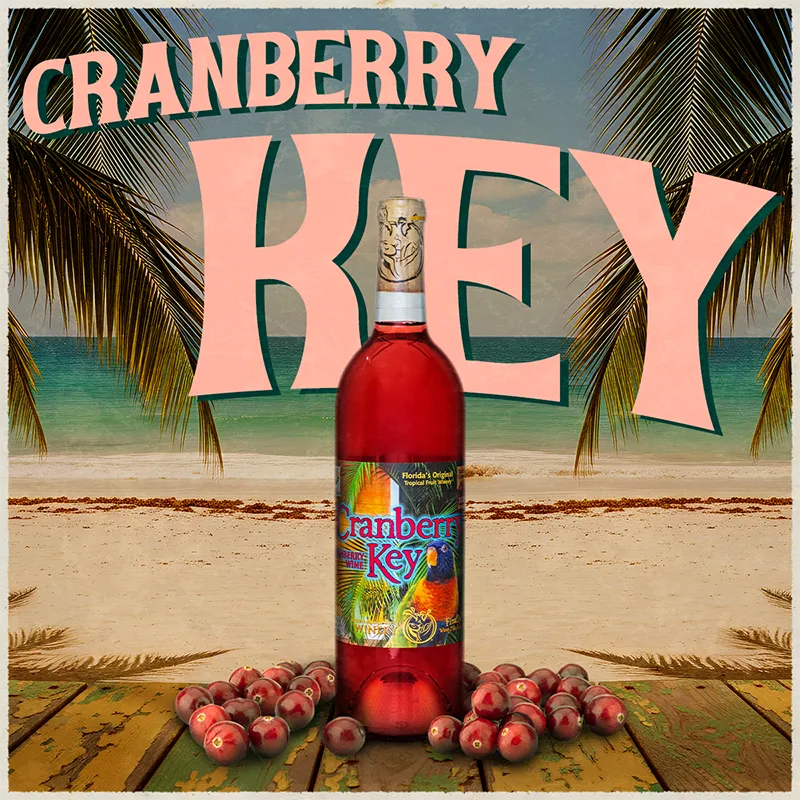 Cranberry Key bottle with cranberries on a beach background