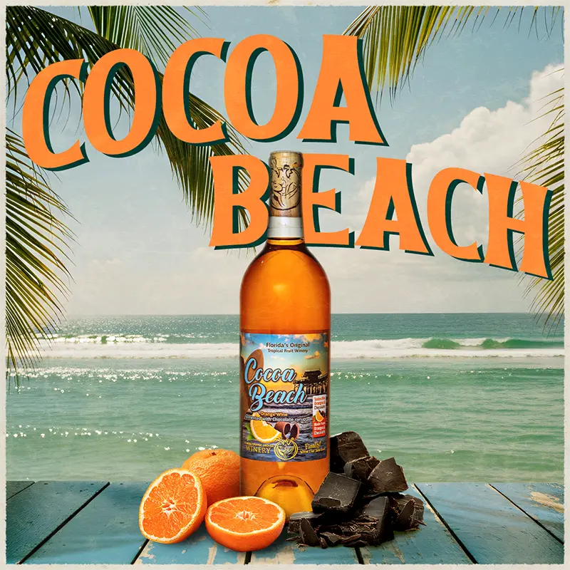 Cocoa Beach bottle with oranges and chocolate on a beach background
