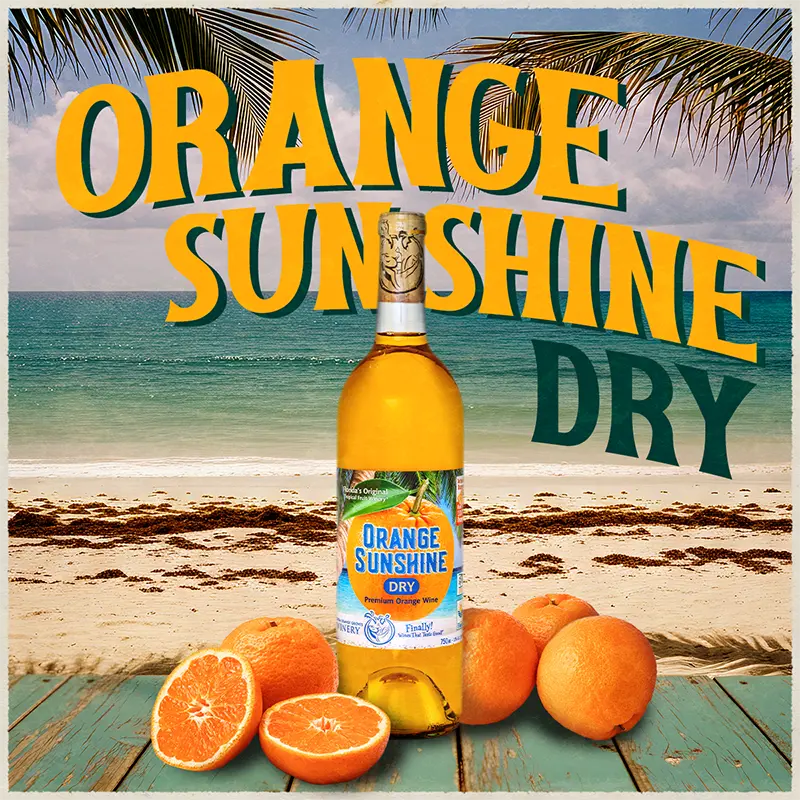Bottle of Orange Sunshine Dry with oranges on a beach background