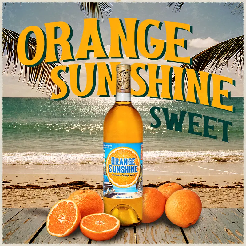 Bottle of Orange Sunshine sweet orange wine with oranges on a beach background