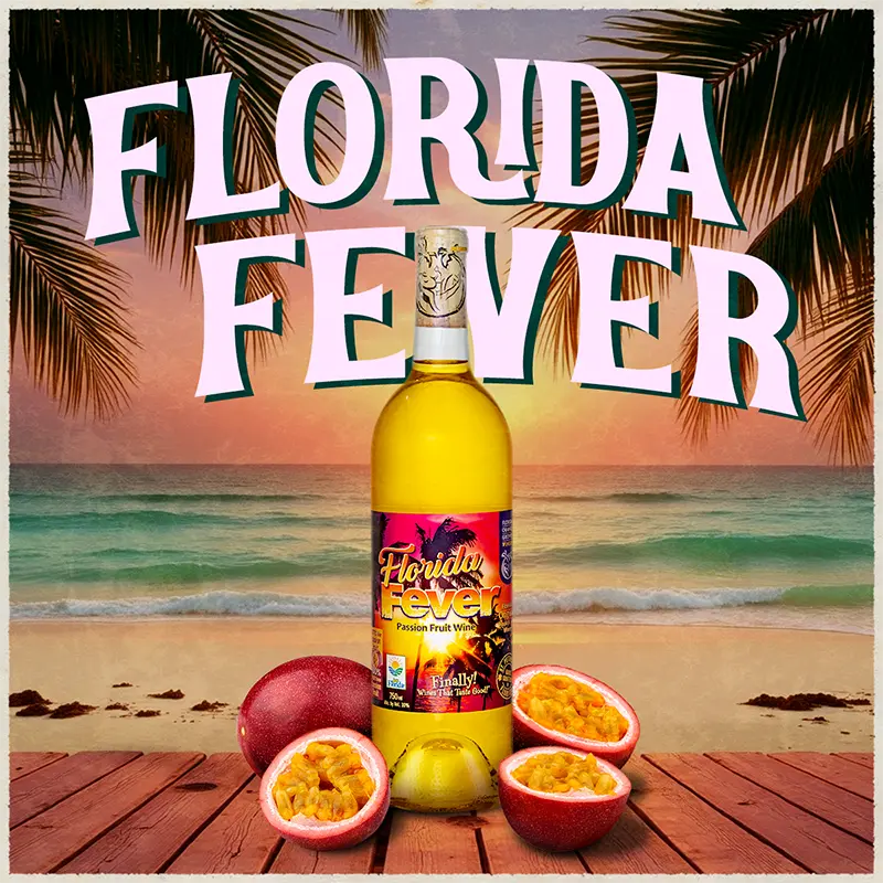 Bottle of Florida Fever wine with passion fruits on a beach setting