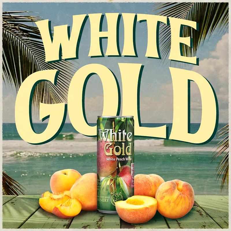 Can of White Gold White Peach wine with peaches on a beach setting