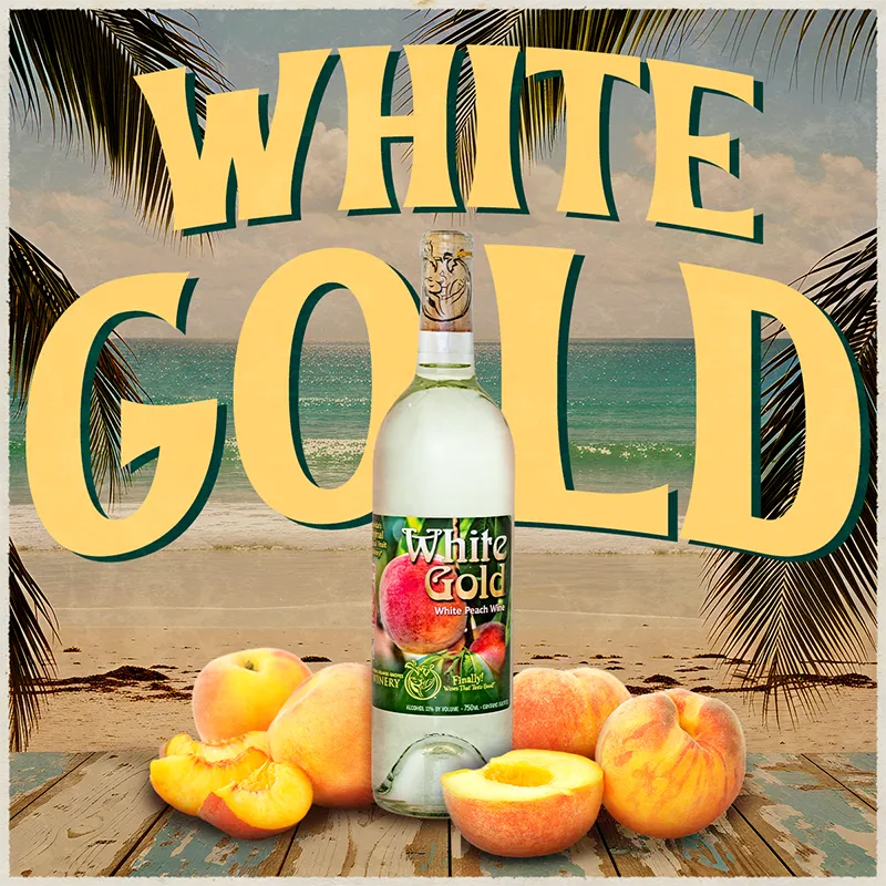 Bottle of White Gold peach wine with peaches on a beach setting