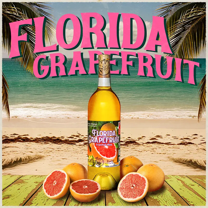 Bottle of Florida Grapefruit wine with grapefruits on a beach background