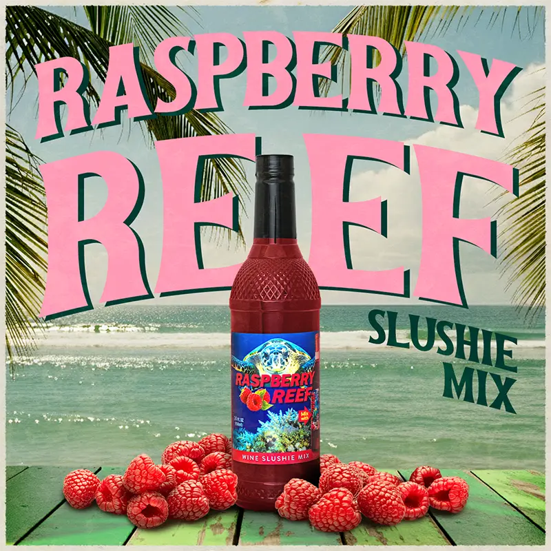 Bottle of Raspberry Reef slushie mix with raspberries on a beach background