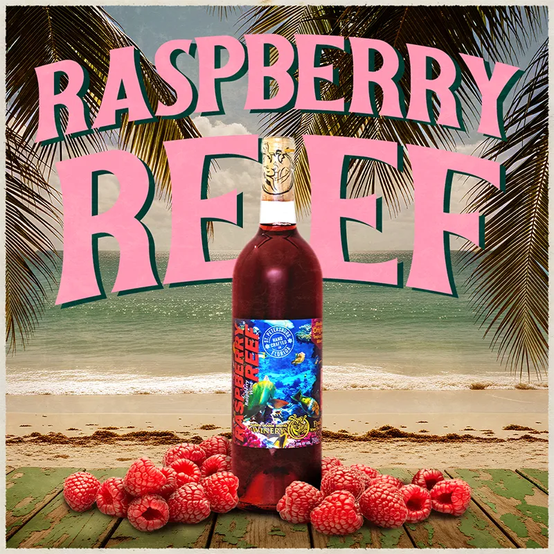 Bottle of Raspberry Reef with raspberries on a beach background