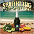 Bottle of Hurricane sparkling wine with tropical fruits on a beach setting