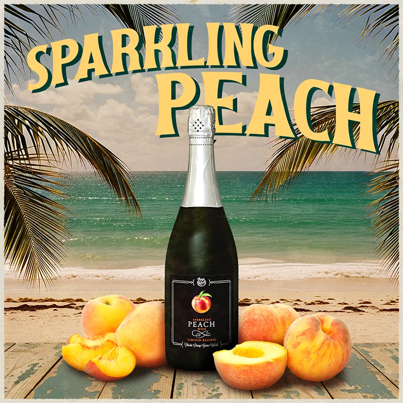 Bottle of sparkling peach wine with peaches on a beach setting
