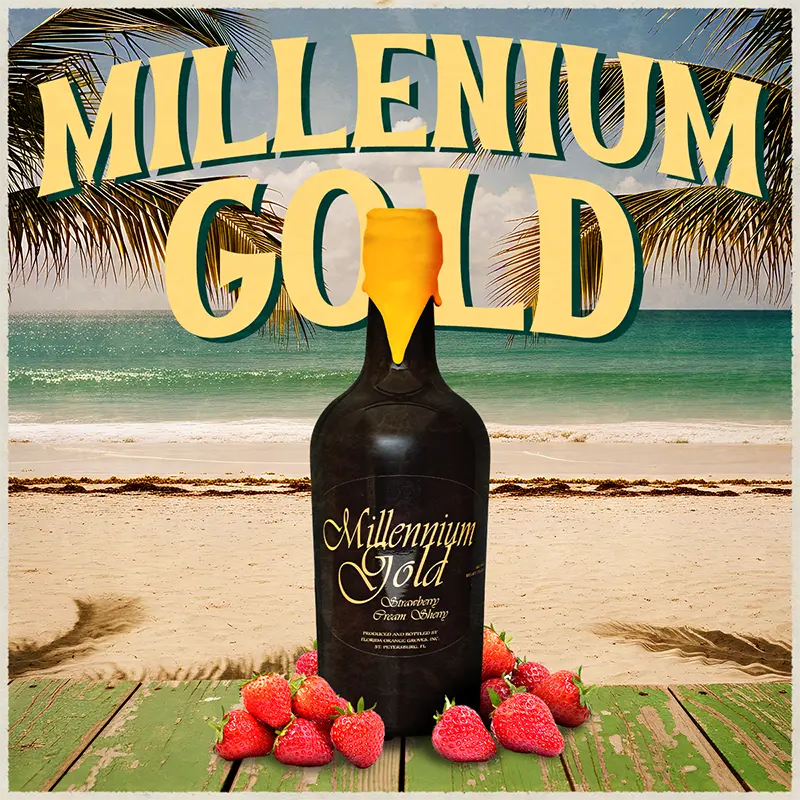Bottle of Millennium Gold sherry with strawberries on a beach background
